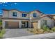 Striking two-story home with two garages, a paved driveway and desert landscaping at 195 Cactus Sunrise St, Las Vegas, NV 89138