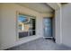 Covered front porch with a modern front door and stone paver flooring at 195 Cactus Sunrise St, Las Vegas, NV 89138