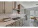 Modern kitchen with gray cabinets, quartz countertops, stainless steel appliances, and a gas cooktop at 195 Cactus Sunrise St, Las Vegas, NV 89138