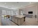 Open-concept kitchen and dining area with an island, tile flooring, and modern lighting at 195 Cactus Sunrise St, Las Vegas, NV 89138