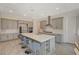 Bright kitchen with stainless steel appliances, gray cabinets and an expansive island at 195 Cactus Sunrise St, Las Vegas, NV 89138