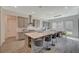 Spacious kitchen with island, gray cabinets, barstool seating, quartz countertop, and dining area at 195 Cactus Sunrise St, Las Vegas, NV 89138