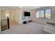 Large living room with a wall-mounted TV, colorful accents, and a view of the surrounding neighborhood at 195 Cactus Sunrise St, Las Vegas, NV 89138