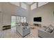 Bright living room with high ceilings, tile floors, and access to the backyard at 195 Cactus Sunrise St, Las Vegas, NV 89138