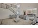 Spacious living room with staircase, tile floors, and an open floor plan to the kitchen at 195 Cactus Sunrise St, Las Vegas, NV 89138