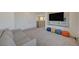 Spacious living room with a comfortable sofa, television, and access to other areas of the house at 195 Cactus Sunrise St, Las Vegas, NV 89138