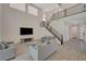 Spacious living room with a modern staircase, tile floors, and a fireplace at 195 Cactus Sunrise St, Las Vegas, NV 89138