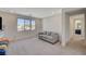 Cozy living room with neutral tones, comfortable sofa, and a large window offering natural light and neighborhood views at 195 Cactus Sunrise St, Las Vegas, NV 89138