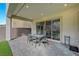 A covered patio with a stone floor offers outdoor seating and dining space at 195 Cactus Sunrise St, Las Vegas, NV 89138