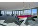 Luxurious game room featuring a billiards table and panoramic city views from large windows at 200 Hoover Ave # 1210, Las Vegas, NV 89101