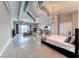 Spacious living area with industrial-chic exposed ductwork, a modern kitchen, and expansive city views through large windows at 200 Hoover Ave # 1210, Las Vegas, NV 89101