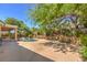 Landscaped backyard with a sparkling pool, mature trees, and shaded patio area perfect for relaxing and entertaining at 2020 Sinfonia Ave, Henderson, NV 89052