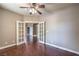 Bedroom with hardwood floors, neutral walls, ceiling fan, and French doors leading to other rooms at 2020 Sinfonia Ave, Henderson, NV 89052