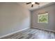 This bedroom has beautiful wood floors and a ceiling fan with a light fixture at 2020 Sinfonia Ave, Henderson, NV 89052