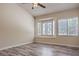 Bright bedroom featuring hardwood flooring, a ceiling fan and a window bench with plantation shutters at 2020 Sinfonia Ave, Henderson, NV 89052