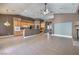 Open-concept living space with tan tile floors, wood cabinets, stainless appliances, and dining area at 2020 Sinfonia Ave, Henderson, NV 89052