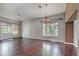 Bright living room boasting hardwood floors, large windows with natural light, and stylish chandelier at 2020 Sinfonia Ave, Henderson, NV 89052