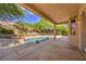 Stunning backyard pool with water feature, mature landscaping, and covered patio area at 2020 Sinfonia Ave, Henderson, NV 89052