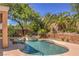 Backyard pool with rock waterfall feature and lush landscaping, perfect for relaxing and entertaining at 2020 Sinfonia Ave, Henderson, NV 89052