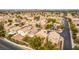 Expansive aerial view of a residential neighborhood with well-maintained homes and mature trees in a suburban setting at 2199 Timescape Ct, Las Vegas, NV 89123