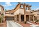 Inviting home with a two-car garage, landscaped front yard, and charming covered porch at 2199 Timescape Ct, Las Vegas, NV 89123