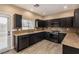 Beautiful kitchen boasts modern appliances, sleek dark cabinets and granite countertops at 2199 Timescape Ct, Las Vegas, NV 89123