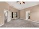 Large main bedroom featuring a ceiling fan, carpet flooring, and ensuite bathroom at 2199 Timescape Ct, Las Vegas, NV 89123