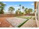 Lush backyard with mature trees and desert landscaping, as well as brick paver design at 2295 Aria Dr, Henderson, NV 89052