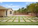 Large backyard area showcasing decorative brick and turf paver design at 2295 Aria Dr, Henderson, NV 89052