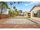 Spacious backyard with desert landscaping, privacy wall, and brick paver design at 2295 Aria Dr, Henderson, NV 89052