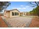 Full backyard view of a home with decorative brick and turf paver design at 2295 Aria Dr, Henderson, NV 89052