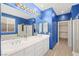 Beautiful bathroom featuring double sinks, a large mirror, and a walk-in shower, creating a luxurious space at 2295 Aria Dr, Henderson, NV 89052