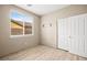 Empty bedroom with a window, closet and wood-look floors at 2295 Aria Dr, Henderson, NV 89052