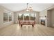 Inviting dining area with vaulted ceilings, a cozy fireplace, and large windows offering plenty of natural light at 2295 Aria Dr, Henderson, NV 89052