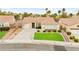 Charming single-story home with a well-maintained lawn, mature trees, and a spacious driveway at 2295 Aria Dr, Henderson, NV 89052