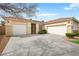 Attractive home featuring a well-manicured lawn, mature trees, and a three-car garage at 2295 Aria Dr, Henderson, NV 89052
