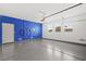 Spacious garage featuring epoxy floors and blue accent wall at 2295 Aria Dr, Henderson, NV 89052