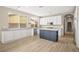 Spacious kitchen with white cabinets, an island, and stainless steel appliances at 2295 Aria Dr, Henderson, NV 89052