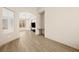 Open living space featuring wood-look flooring, an arched entryway, and modern fixtures at 2295 Aria Dr, Henderson, NV 89052