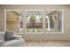 Bright living room view with large windows overlooking a landscaped backyard, featuring natural light and hardwood floors at 2295 Aria Dr, Henderson, NV 89052