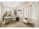 Home office space featuring a modern desk, comfortable chair, and natural light from multiple windows at 2295 Aria Dr, Henderson, NV 89052