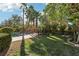Serene backyard featuring a pool, grassy lawn, and mature landscaping, ideal for relaxing and enjoying the outdoors at 2323 Carinth Way, Henderson, NV 89074
