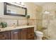 Elegant bathroom featuring granite countertops, glass shower enclosure, and wood cabinetry at 2323 Carinth Way, Henderson, NV 89074