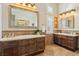 Bright bathroom features dual vanities, a decorative tile backsplash and shuttered windows at 2323 Carinth Way, Henderson, NV 89074