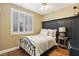 Cozy bedroom features a wrought iron bed frame, and shuttered windows at 2323 Carinth Way, Henderson, NV 89074