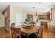 Elegant dining area adjacent to kitchen, with custom cabinets and stainless steel appliances at 2323 Carinth Way, Henderson, NV 89074