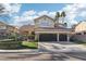 Charming two-story home features a large 2-car garage, lush landscaping, and a well-maintained lawn at 2323 Carinth Way, Henderson, NV 89074