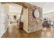 Inviting foyer with hardwood floors, custom brick wall, and staircase leading to the upper level at 2323 Carinth Way, Henderson, NV 89074