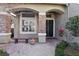 Charming covered front porch with stone accents and a cozy bench at 2323 Carinth Way, Henderson, NV 89074