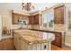 Gourmet kitchen featuring granite countertops, custom wood cabinetry, and stainless steel appliances at 2323 Carinth Way, Henderson, NV 89074